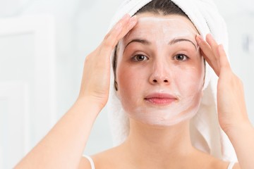 Woman applying face mask