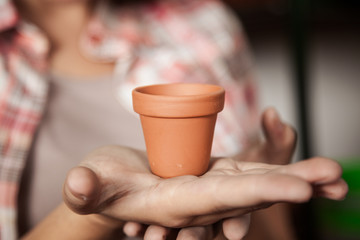 Woman showing flower pot