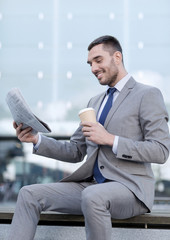 young businessman with coffee and newspaper