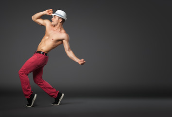 Young male professional dancer dancing in studio.