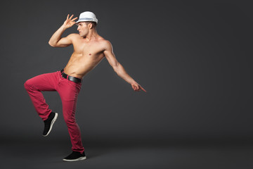 Young male professional dancer dancing in studio.