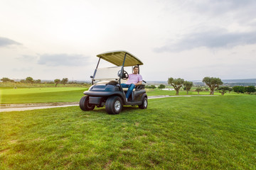 golf man in cart enjoy