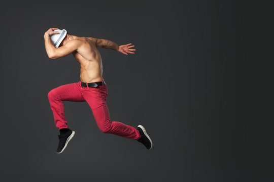 Young Male Dancer Jumping In Studio.