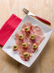 parma ham with stuffed tomatoes, traditional italian appetizer
