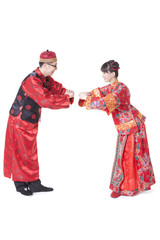 Young couple greeting for Chinese New Year in traditional Chinese clothing