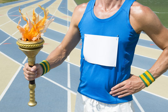 Athlete wearing blank race bib holding sport torch in front of running track