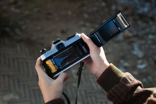 Hand loading film into camera - Powered by Adobe