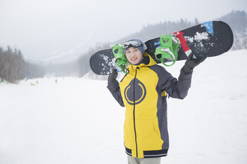 Young man with snowboard on the snow