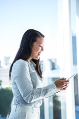 Smiling businesswoman using smartphone