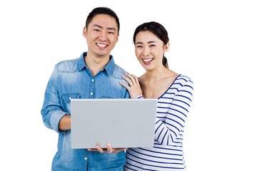 Portrait of couple using laptop