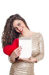 Beautiful Caucasian girl holding empty paper pad and smiling, copy space, valentines day concept