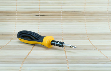 screw driver on bamboo matting - 99541820