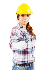 Woman in construction helmet with wrench in the right hand