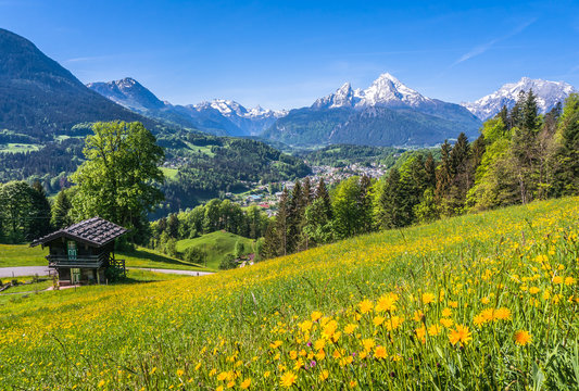 Idyllic landscape in the Alps with traditional mountain lodge in springtime