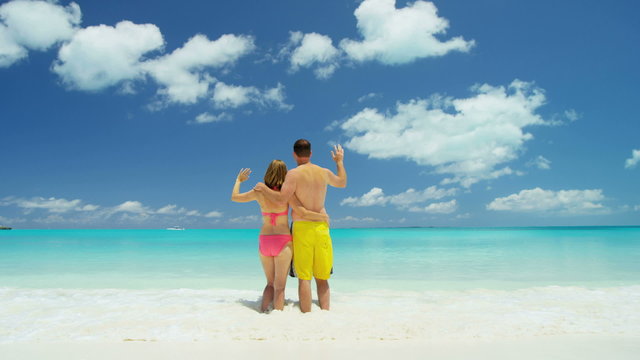 Young Caucasian couple in swimwear on a luxury beach vacation