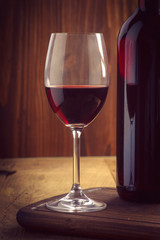 glasses and bottle of wine on old wood
