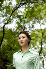 Businesswoman Standing Outside Holding Folder