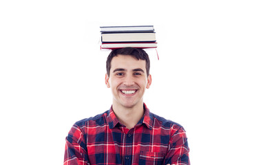 Smiling student young man holding books on his head over white background.