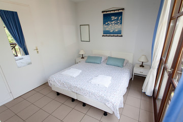 Double Bed In The Bedroom With Desk Lamp Near It
