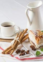 close up of ring-shaped cake with icing sugar, cream, mint, cinn