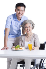 Obraz na płótnie Canvas Disabled senior woman having breakfast in nursing home