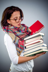 Female librarian holding a pile of books