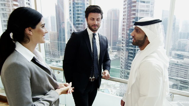 Middle East male female business team meeting stocks shares trading commodities