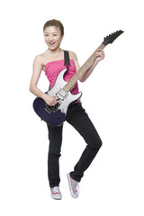 Fototapeta premium Young woman playing an electric guitar