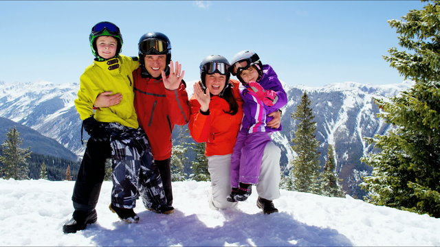 portrait winter skiing vacation Caucasian family parents children snow resort