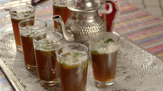 an elderly man serving traditional Moroccan tea