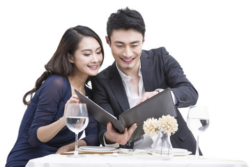 Young couple reading menu in restaurant