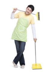 Young man with broom and dustpan