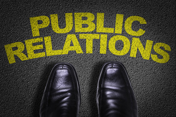 Top View of Business Shoes on the floor with the text: Public Relations