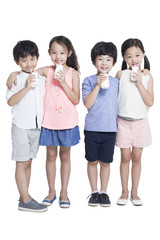 Happy children drinking yogurt