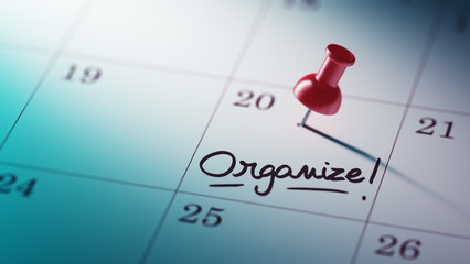 Concept image of a Calendar with a red push pin. Closeup shot of