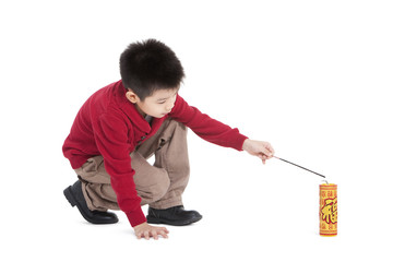 Little boy igniting firecracker