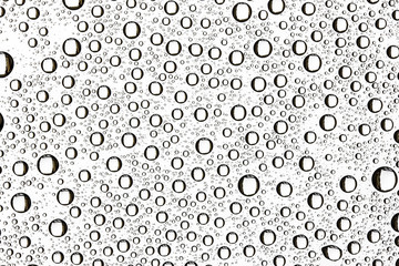 Water drops on transparent glass background.