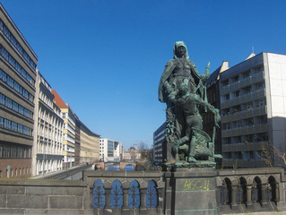 Fototapeta na wymiar Old statue on a bridge over a river in Berlin, Germany