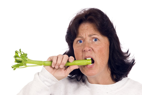 Choosing To Eat Healthy/ Overweight Woman Trying To Eat Healthy And Lose Weight By Eating Celery.  On White Background