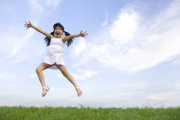 Fototapeta na wymiar Girl jumping in mid-air
