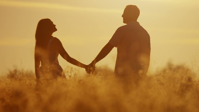 Carefree Caucasian Couple Enjoying Vacation Together Outdoors Sunrise Silhouette