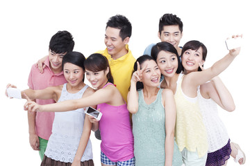 Fototapeta premium Group of young friends using mobile phones to do self portrait 