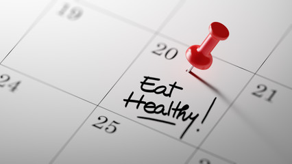 Concept image of a Calendar with a red push pin. Closeup shot of