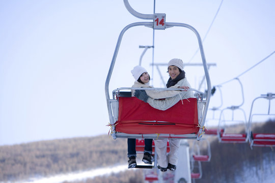 Young couple on a ski lift