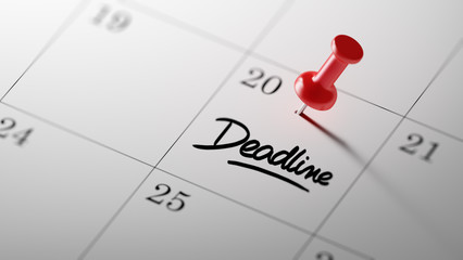 Concept image of a Calendar with a red push pin. Closeup shot of