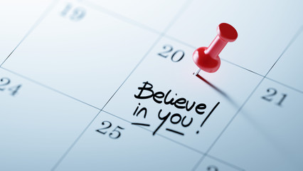 Concept image of a Calendar with a red push pin. Closeup shot of