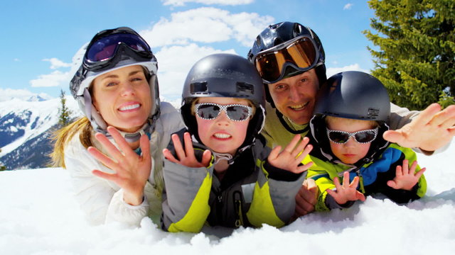 portrait young Caucasian parents sons outdoor snow recreation teamwork