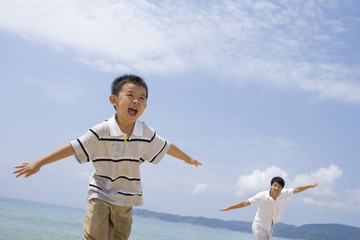 Father and son playing on the beach