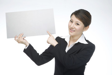 Young businesswoman holding a white board