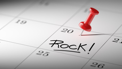 Concept image of a Calendar with a red push pin. Closeup shot of